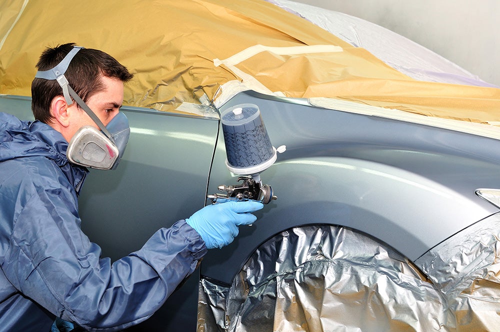 person repainting the car